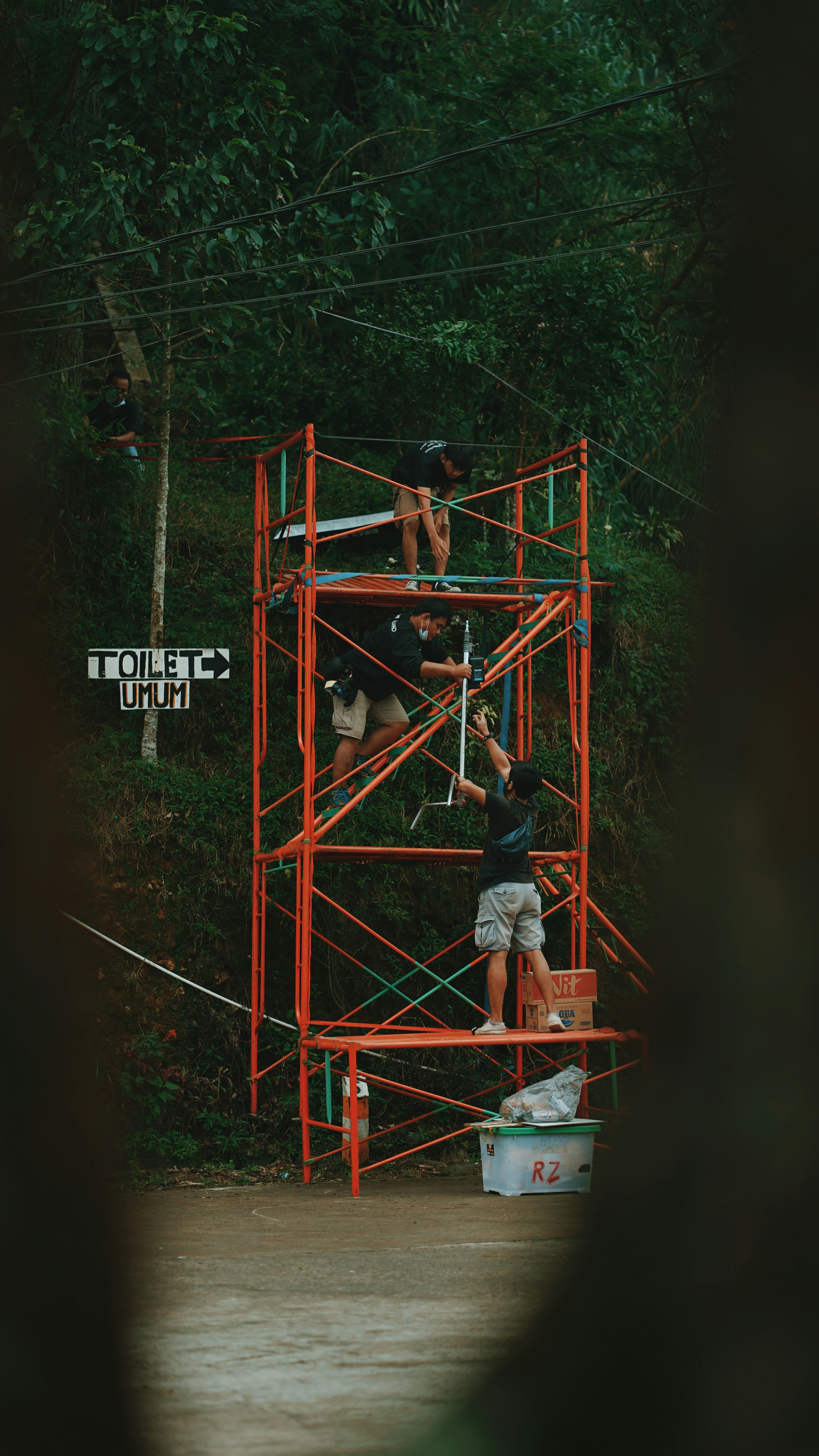 2 men on red metal frame